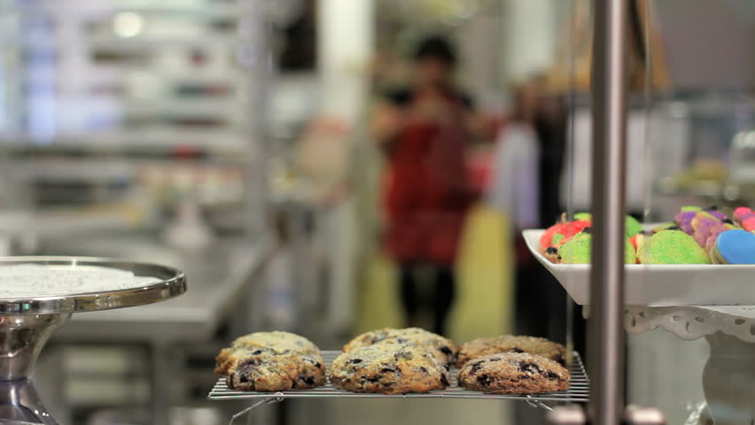 Woman puts pie on display at a bakery