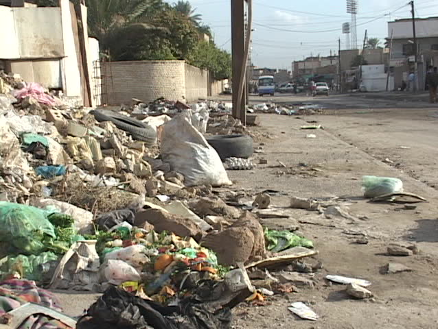 Trash fills the sidewalks and falls into the streets in war-torn Baghdad, Iraq.