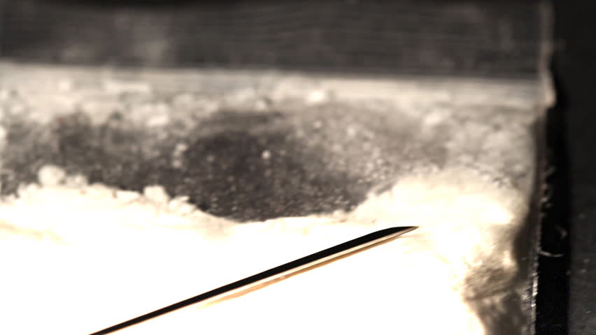 Hard drug - addiction concept. ILLUSTRATION! The white powder is flour before anyone think something else :-)  Studio setup with professional lighting and dolly motion.
