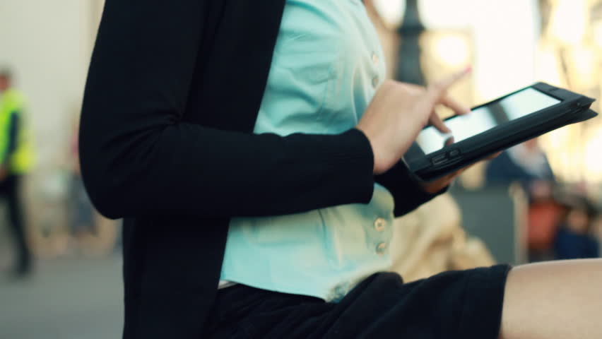 Businesswoman with tablet computer in the city, camera stabilizer shot