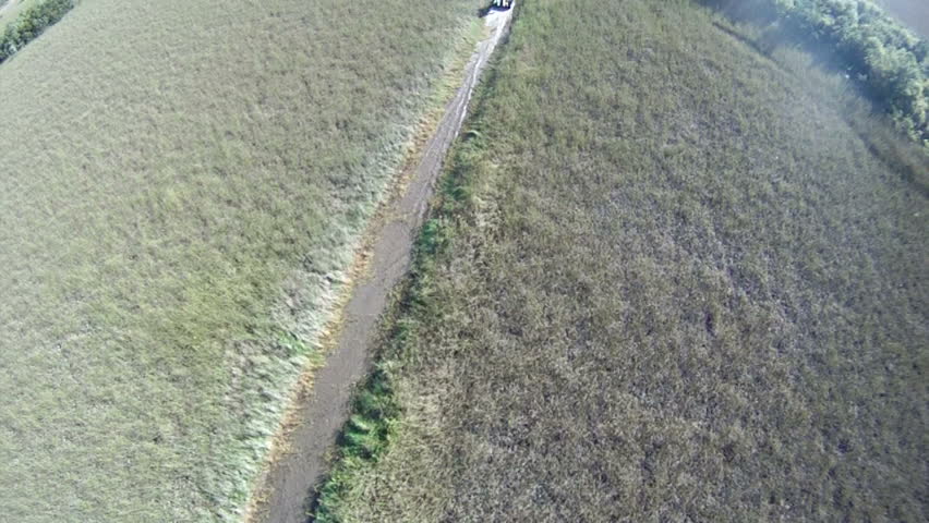Aerial - Following airboat down narrow canal