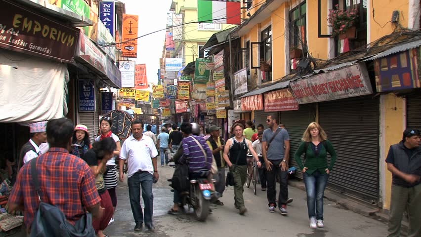 KATHMANDU - CIRCA 2010: People, cars and bikes circulate through the city circa 2010 in Kathmandu.