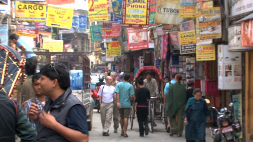 KATHMANDU - CIRCA 2010: People, cars and bikes circulate through the city circa 2010 in Kathmandu.