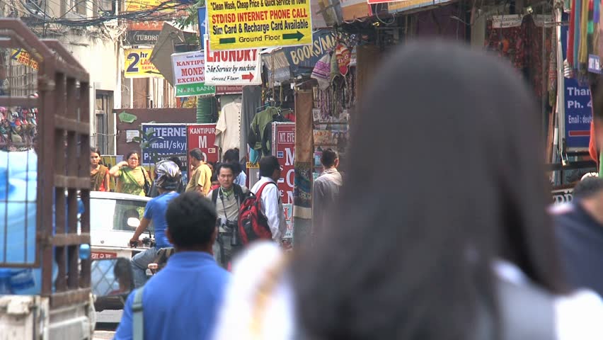 KATHMANDU - CIRCA 2010: People, cars and bikes circulate through the city circa 2010 in Kathmandu.