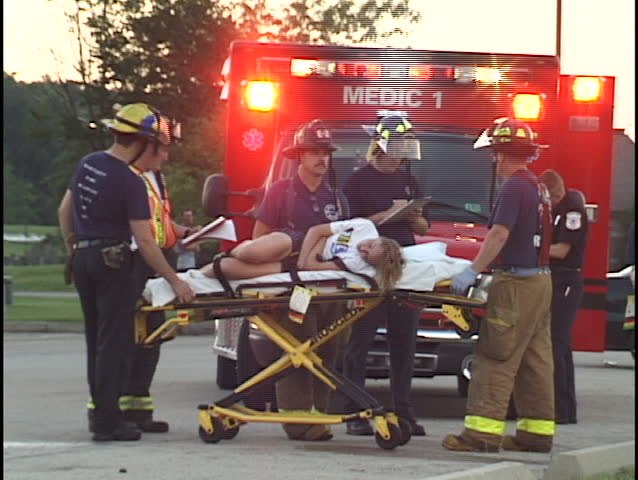 paramedics treat woman on gurney 1
