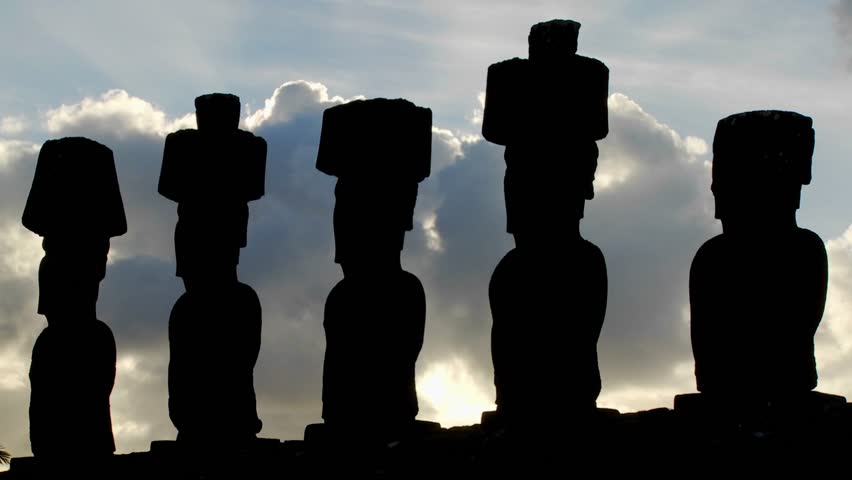 Clouds move mysteriously behind Easter Island statues.