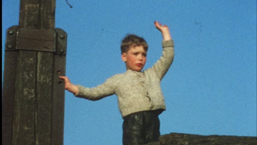 Boy waving goodbye (Vintage 8 mm amateur film)