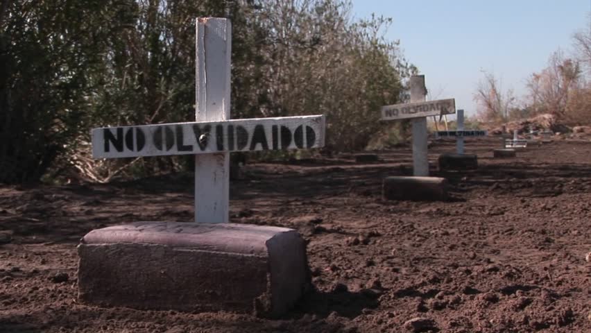 Graves are marked with signs stating they are not forgotten.