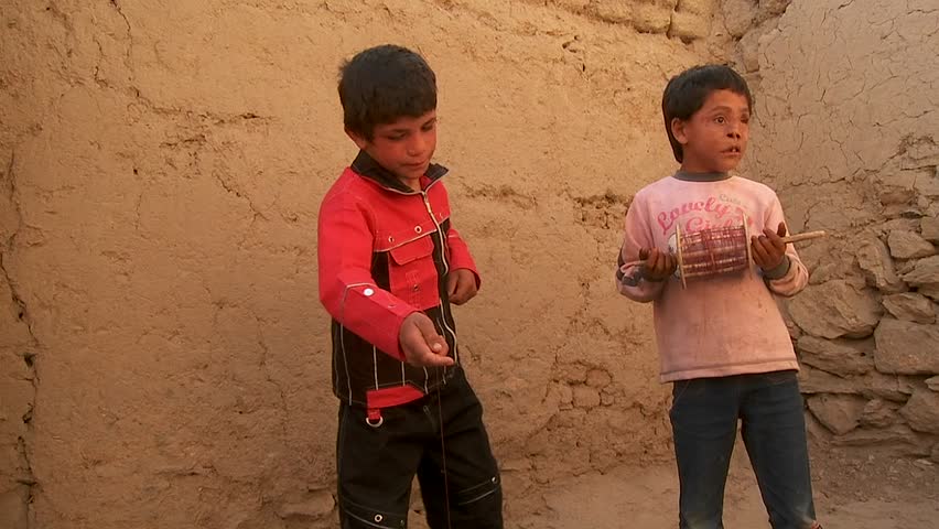 KABUL, AFGHANISTAN - CIRCA 2009: A blind child and friend play with broken kites circa 2009 in Kabul, Afghanistan. Afghanistan is an impoverished and least developed country, one of the world's poorest. 