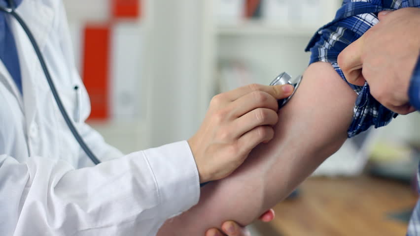 Doctor measuring blood pressure, close up