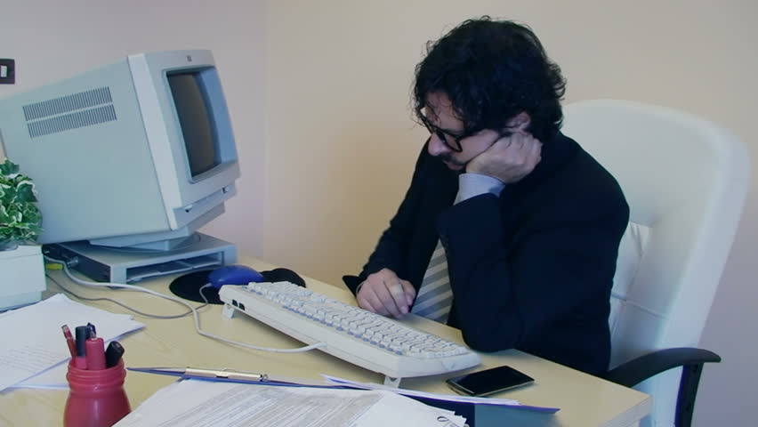 A male employee at work in the office is annoyed and depressed. He gets mad at his pc, then turns off the monitor and leaves.