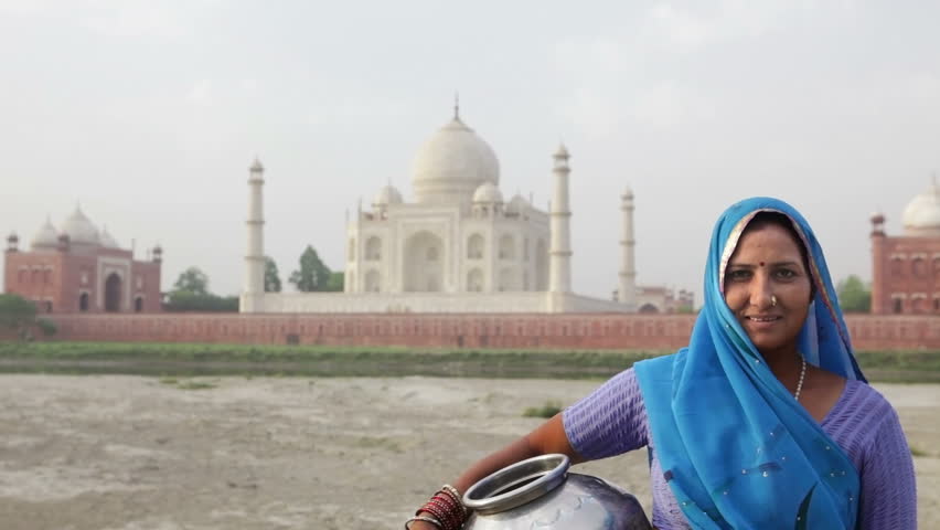Indian Woman in traditional Sari in front of Taj MahalIndian Woman in traditional Sari in front of Taj Mahal, Agra, Uttar Pradesh, India