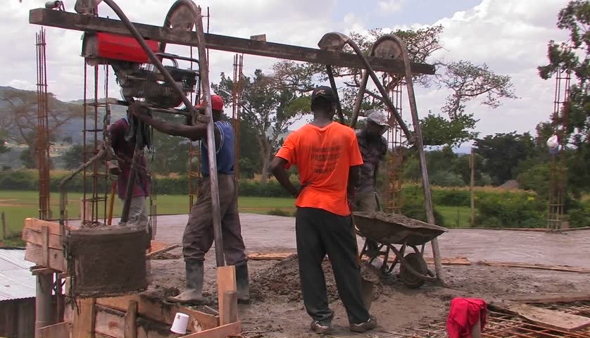 KENYA, AFRICA - CIRCA 2009: Men on a construction site do cement work circa 2009 in Kenya.