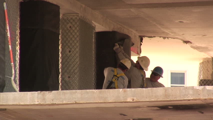 WEST PALM BEACH,  FL - FEB 13:  Workers begin clean up  at the Flagler condo site after the implosion on February 13, 2010 In West Palm Beach, Florida. 