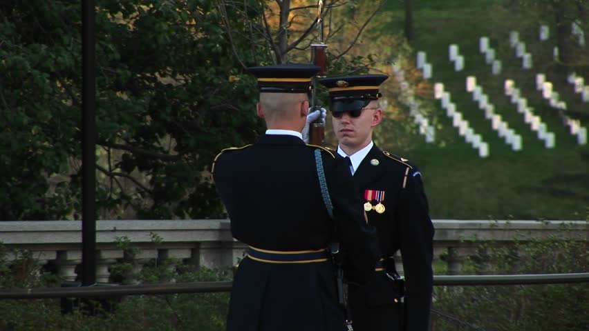 WASHINGTON, D.C. - CIRCA 2009: A soldier stands at attention in full uniform as another soldier inspects his gun.