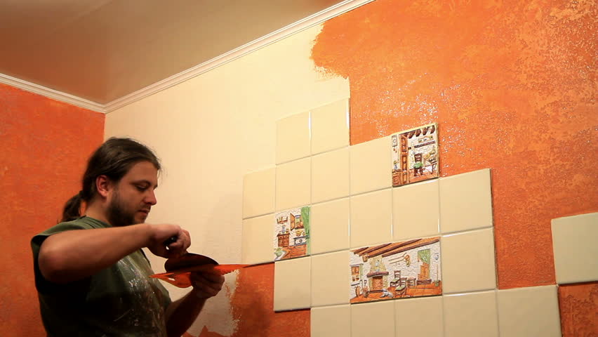 Master applies colored wax on ornamental plaster. 