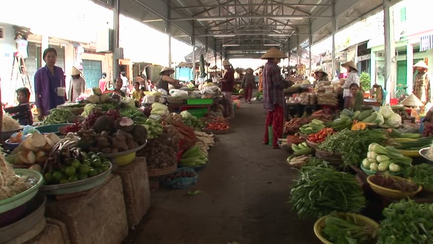 VIETNAM - CIRCA 2009: POV of people selling produce at open market circa 2009 in Vietnam.
