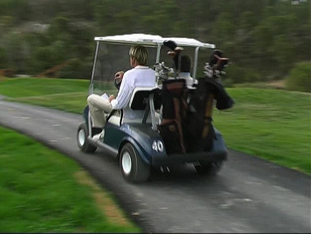 2 Caddies speeding to the next tee