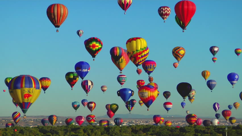 ALBUQUERQUE, NM - CIRCA 2009: Hot air balloons rise against a blue sky at the Albuquerque Balloon Festival circa 2009 in Albuquerque.
