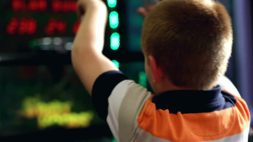 Boy playing basketball arcade over the shoulder