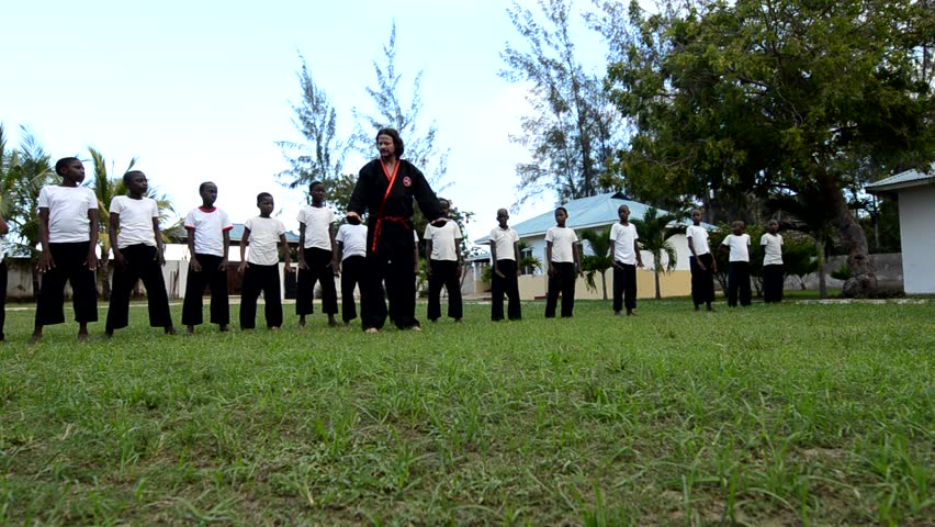 MALINDI, KENYA - OCTOBER 16: A group of unidentified children in an orphanage are instructed by a teacher on the discipline of martial arts on October 16, 2011 in Malindi, Kenya. 