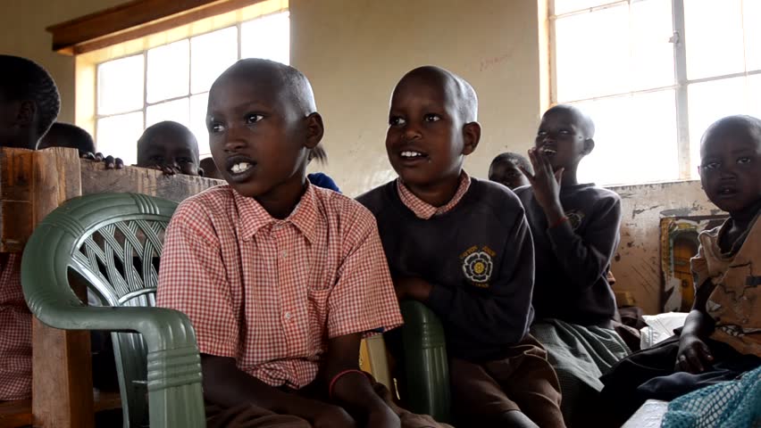 MASAI MARA, KENYA - OCTOBER 17: Unidentified schoolboys sit in a  school funded by tourists' donations on October 17, 2011 in Masai Mara, Kenya. 