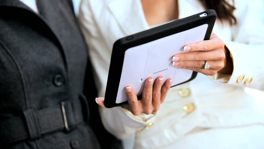 Two Businesswomen Using Wireless Technology Outdoors