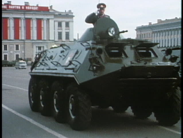 MOSCOW, RUSSIA - CIRCA 1970: An old poster of a Soviet leader looks down upon a military parade.