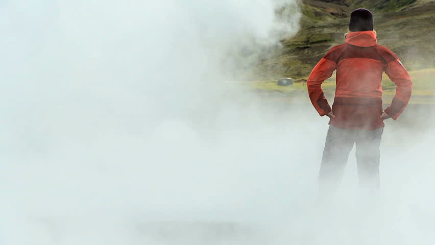 Female on Trekking Expedition Amongst Rising Volcanic Steam