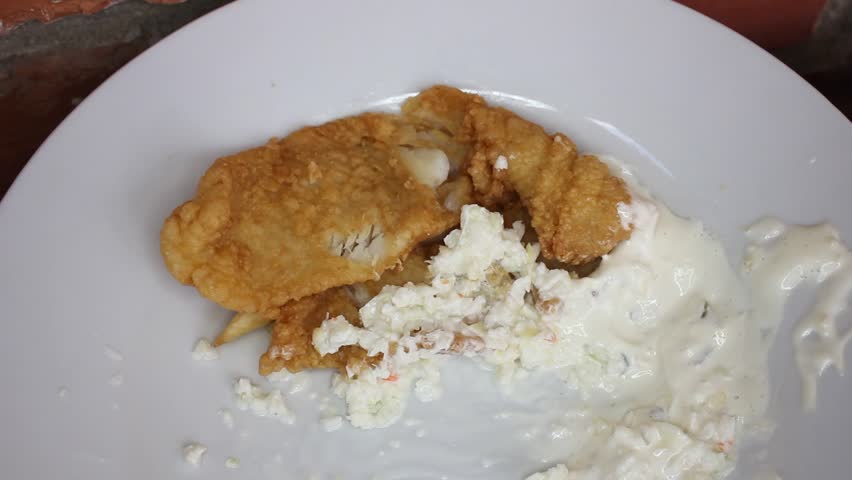 Dipping And Moving A Piece Of Flounder On A Plate