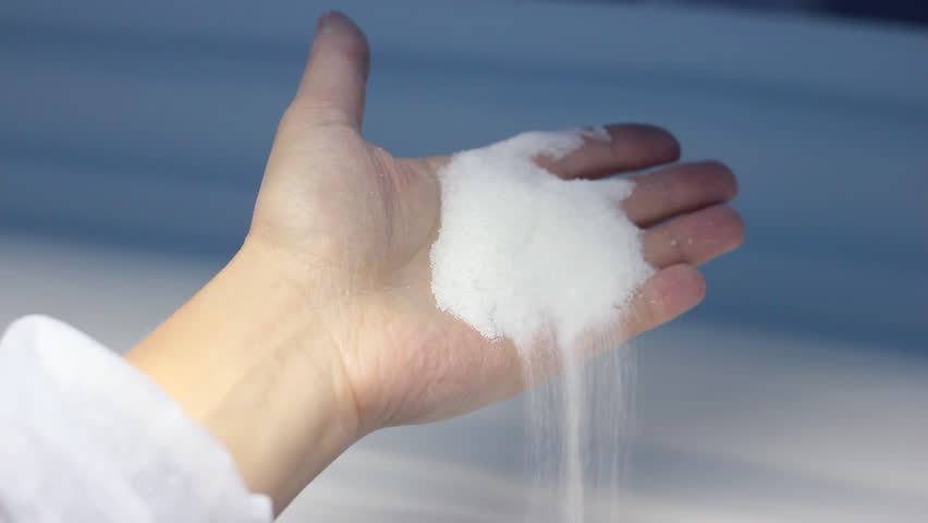 Worker control the quality of sugar on the production line