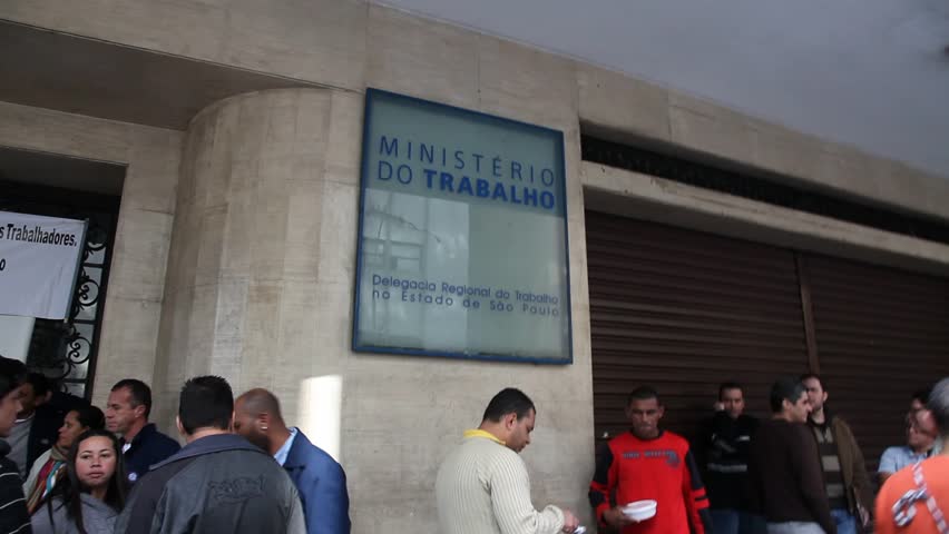 SAN PAULO, BRAZIL - CIRCA JUNE 2011: A line of people stand in front of the Ministry of Labor in protest circa June 2011 in San Paulo.