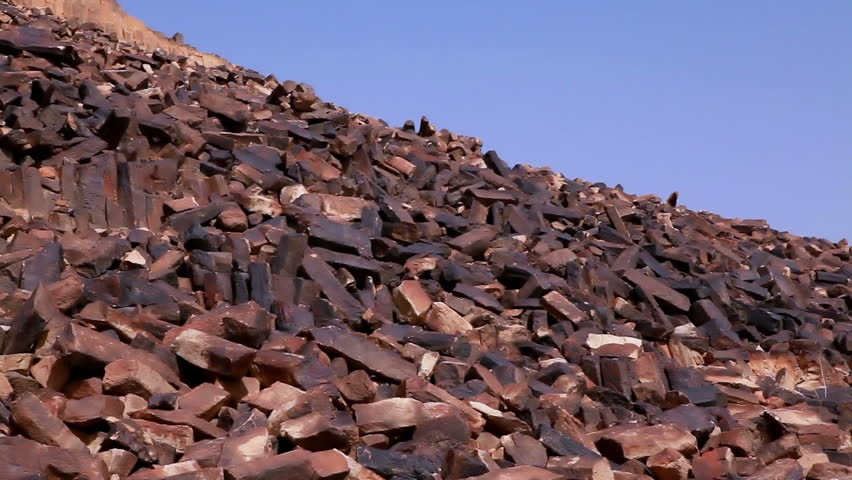 Low angled image of the rocky hillside of Ha-Minsara (The Carpentry Shop), a geological formation in the Mitzpe Ramon Crater in Israel.  
