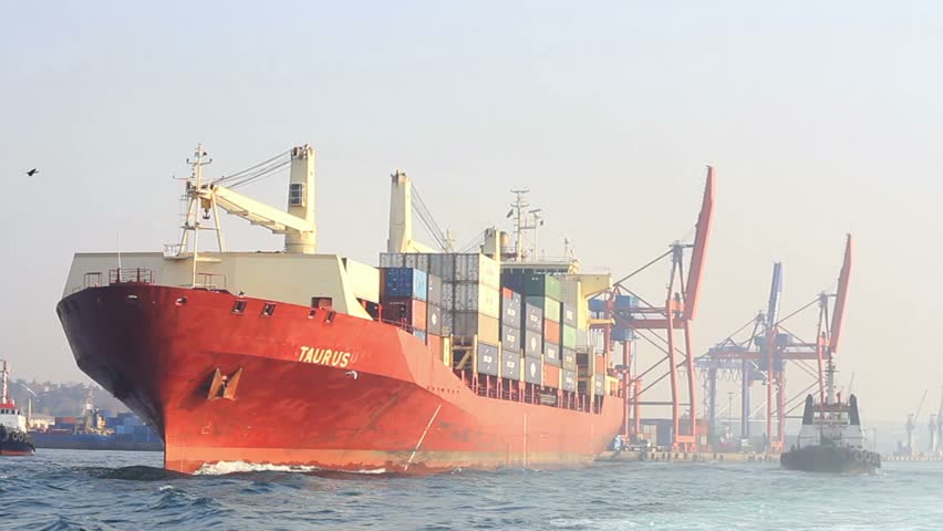 ISTANBUL - DECEMBER 01: Haydarpasa Port on December 01, 2011 in Istanbul, Turkey. Container ship TAURUS (Flag: Marshall Is, IMO: 9134593) sails from the harbor between two of tug boats 