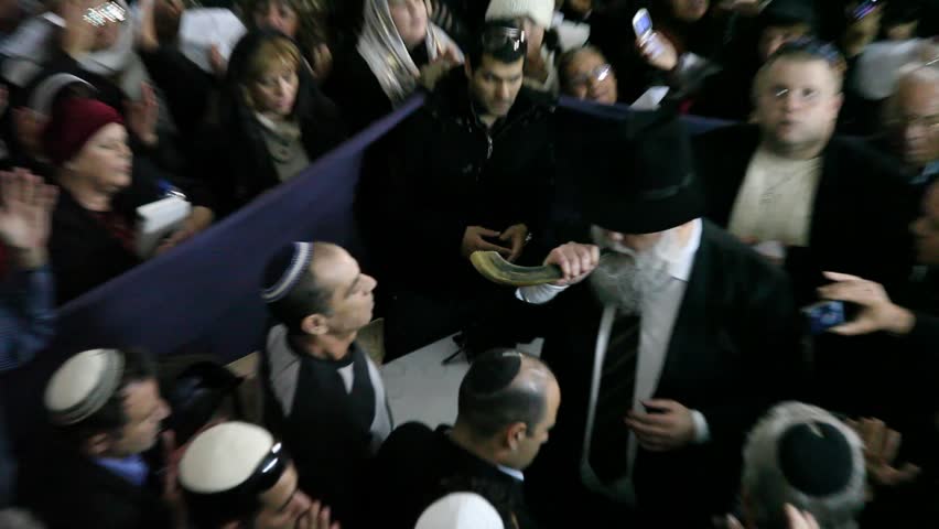 KIRYAT ATTA, ISRAEL - DEC 9, 2009: Rabbi Mamo Shalita blows into a horn at the Tomb of the Prophet Samuel on December 9, 2009 in Kiryat Atta.