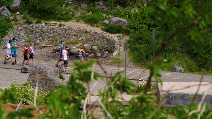PROVO CANYON, UTAH - CIRCA 2010: A group of teenagers walking along the paved path that leads to Bridal Veil Falls in Provo Canyon, Utah.
