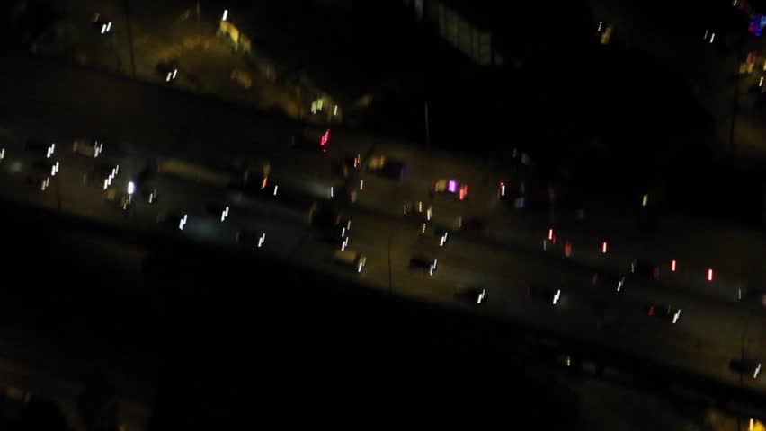 Circling aerial view of emergency lights and vehicles on bridge after car accident