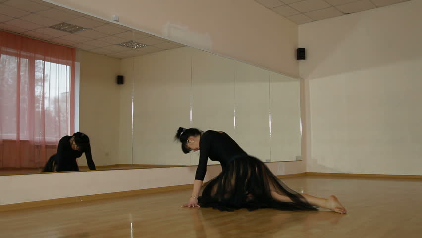 workout elements of contemporary dance in front of a mirror in the dance studio