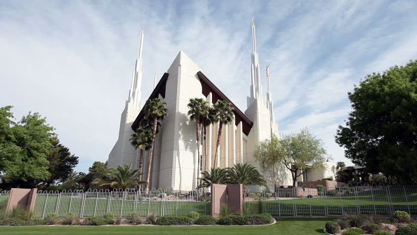Mormon LDS Temple in Las Vegas Nevada. Beautiful gardens blue skies and clouds gently drifting past spires. Christian religion. Most sacred and Holy edifice of their belief for worship and learning.