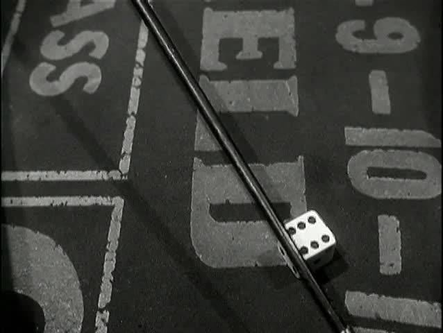 Close-up clearing dice on craps table