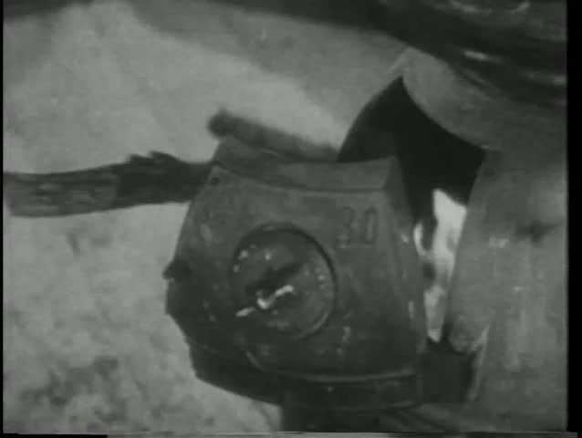 Close-up hand tending fire in wood burning stove