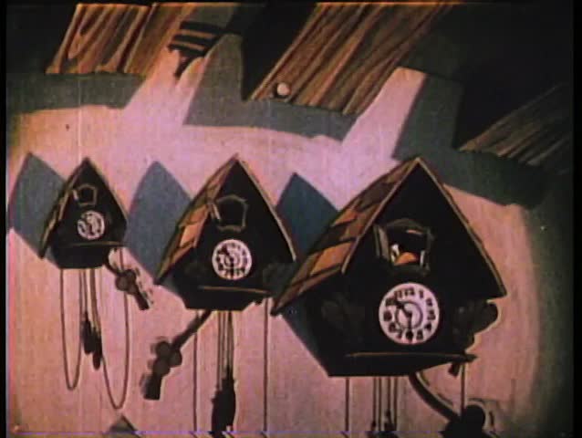 Animated cuckoo clocks arranged on wall from smallest to largest
