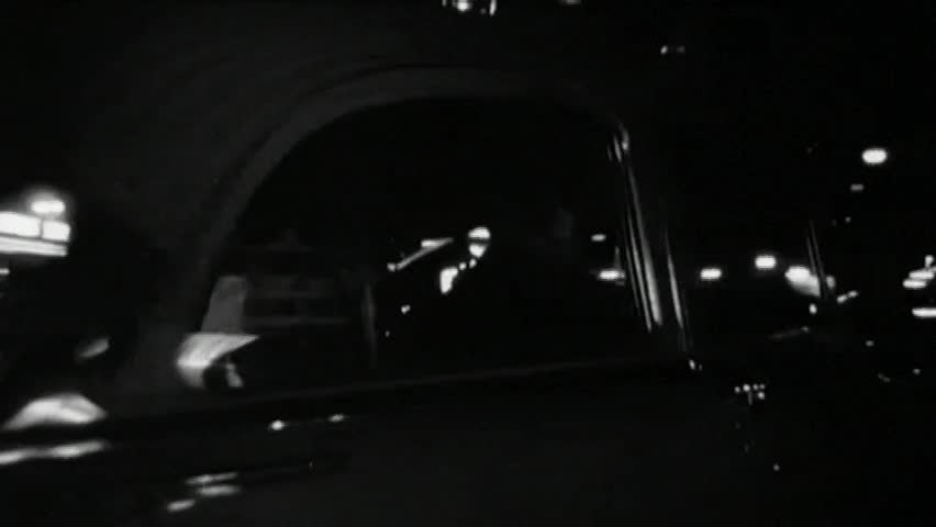 Police cruiser following car at night