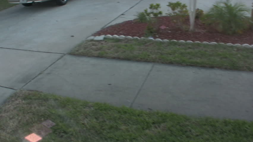 Jib shot revealing mailbox and person opening to check for mail. (1080i HD)