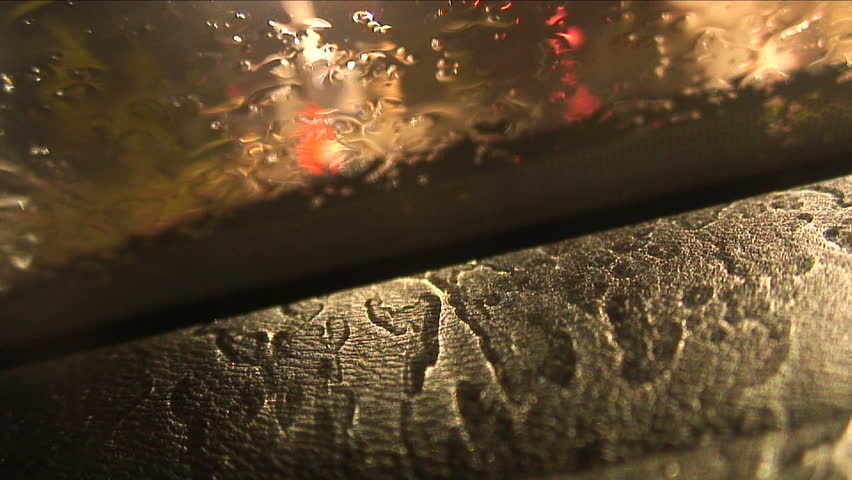Rainy night outside making very sensual patterns on the inside of a car dash.