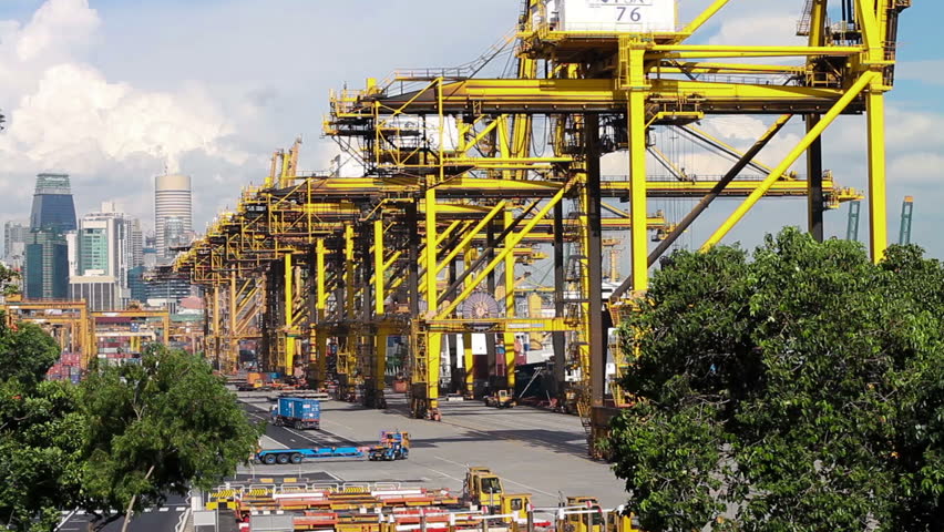 Large gantry cranes, trucks and ship containers at Port of Singapore - the worldÃÂ´s busiest transhipment hub. (1080p, HDSLR).