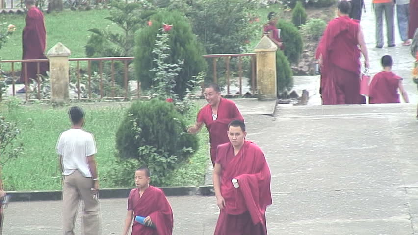 MCLEOD GANJ, INDIA - AUGUST 24, 2006: Tibetan Monks Running in Rain