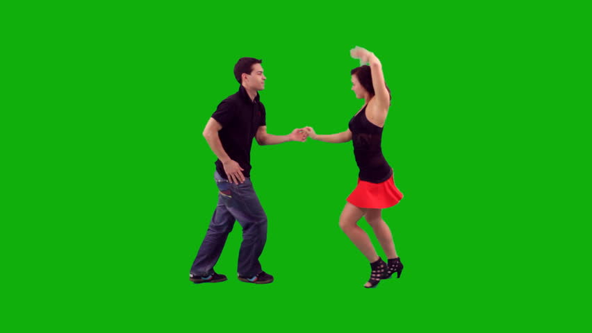 A couple dancing salsa against greenscreen 