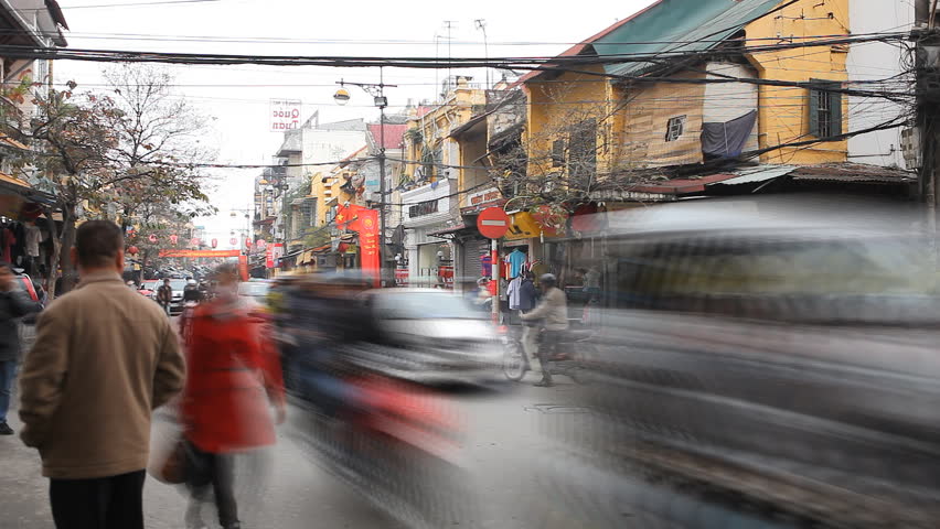 HANOI, VIETNAM - FEBRUARY 15, 2011 Time Lapse of The Bustling Street Scene Old Town, Motorcycles, Cars Traffic