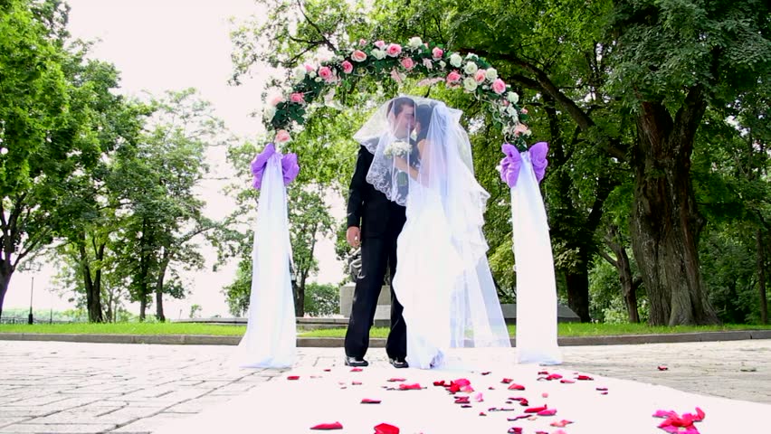 young couple kissing during their wedding ceremony.  dolly shot
